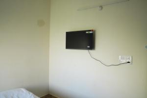 A television and/or entertainment centre at Vasista Homestay