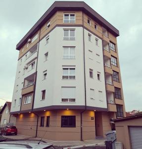a tall white building with a lot of windows at Azimut apartman in Bijeljina