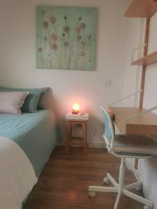 a bedroom with a bed and a desk with a candle at Habitaciones en Centro Histórico Alameda in Seville