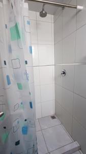 a bathroom with a shower with a glass door at Céntrico Departamento en el Prado in Cochabamba