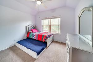 a bedroom with a bed and a mirror and a window at Home with Gazebo 4 Mi to SeaWorld San Antonio! in San Antonio