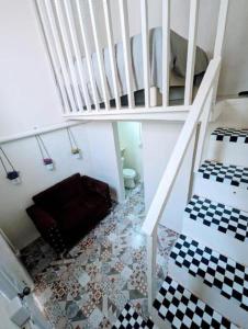 a room with a staircase and a floor with checkered floors at Hostel La Española in Santo Domingo