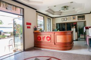 a lobby with a wooden counter in a room at OYO 747 Suwanna Hotel in Krabi