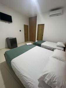 מיטה או מיטות בחדר ב-Hotel Mariscales Sincelejo
