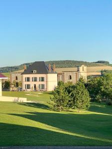 a large house with a large lawn in front of it at Villa Eulalie B&B Guest House nestled in the Champagne area in Bligny