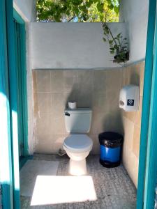a bathroom with a toilet and a trash can at Casa Nicté in Flores