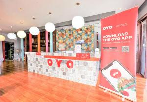an oop store with a counter in a room at OYO 292 The Oddy Hip Hotel in Patong Beach