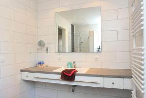 a bathroom with a sink and a mirror at "Windrose" in der Villa am Marienhof in Borkum +11 photos