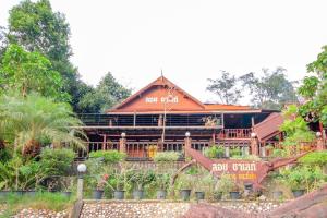 a large building with a sign in front of it at OYO 75353 Loy Chalet Resort in Lan Saka