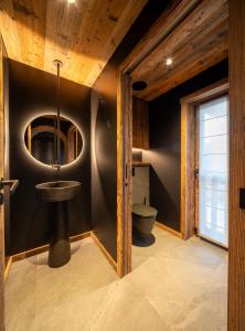 a bathroom with a sink and a toilet at Chalet Enigma in La Clusaz