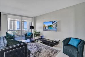 a living room with a couch and two chairs at Gorgeous 4 Bedroom Condo Pool and Stunning Views in Hallandale Beach