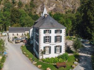 an aerial view of a white building with a church at Domaine Château de Dieupart in Aywaille