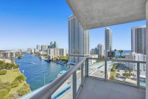 a balcony with a view of a river and buildings at Perfect Vacation Large Condo Breathtaking Views in Hallandale Beach