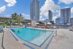 a large swimming pool with people in the water at Perfect Vacation Large Condo Breathtaking Views in Hallandale Beach