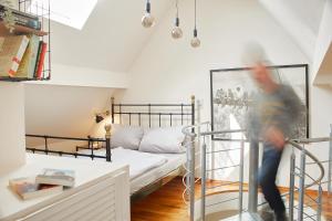 a person jumping off of a bunk bed in a room at Ferienwohnung am Dorfbrunnen in Hundsangen