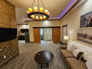 a living room with a couch and a tv at Eaglescape Suites and Event Center in Miles City