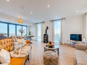 a living room with a couch and a fireplace at The Bungalow in Rushton Spencer