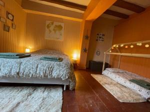 a bedroom with a bed and two rugs at Le Doux Douillet Beauval à 5mn du Zoo - Gite Familial en Hypercentre de Saint-Aignan in Saint-Aignan