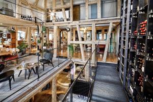 a tasting room with tables and chairs and racks of wine bottles at GAMS zu zweit in Bezau