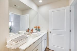 a white bathroom with two sinks and a mirror at Air Home , New Jersey, year 2023 in Sicklerville