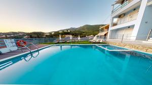 a large swimming pool in front of a building at Mediterraneo Resort in Parga
