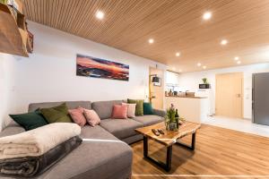 a living room with a couch and a table at MATT - Apartments ' Design ' ruhig & lichtdurchflutet ' Natur in Höchenschwand