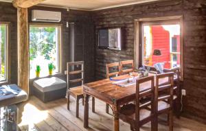 a dining room with a wooden table and chairs at 2 Bedroom Pet Friendly Home In Idkerberget in Idkerberget