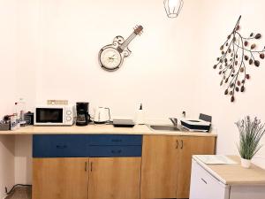 a kitchen with a sink and a clock on the wall at White house parc Carol in Bucharest