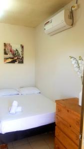 a bedroom with a bed and a air conditioner on the wall at Riveri Salinas host in Salinas