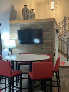 a dining room with a table and chairs and a tv at GrandStay Hotel & Suites in Cambridge