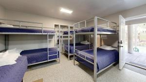 a bunk room with three bunk beds in it at Air Haus in Fourth Crossing