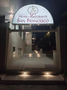 a sign for a san francisco hospital at night at Hotel San Francesco in San Giovanni Rotondo