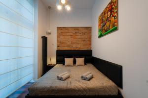 a bedroom with a bed with two pillows on it at Luna Apartment in Krakow