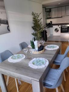 a wooden table with three plates and a christmas tree on it at bonito piso zonas 1'5 del centro in Pamplona