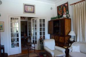 a living room with a couch and a chair at Morbey's Chalet in Sintra