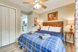 a bedroom with a blue bed with a ceiling fan at Fort Mill Condo with Balcony 3 Mi to Carowinds in Fort Mill