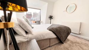 a bedroom with a bed with a mirror and a window at Families And Contractors Welcome! Central Beauty in Liverpool