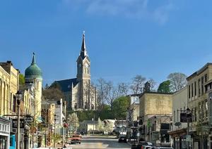 a city street with a church and a clock tower at The Port Hotel in Port Washington +31 photos
