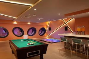a room with a pool table and four mirrors at Dreams Flora Resort & Spa - All Inclusive in Punta Cana