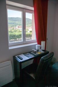 a desk in a room with a window at Hôtel Bar le Globe in Saint Die