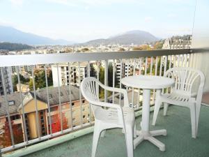 a table and chairs on a balcony with a view at Résidence Le Cheverny - Studio pour 2 Personnes 664 in Aix-les-Bains