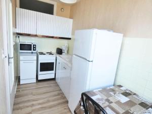 a kitchen with white appliances and a white refrigerator at Résidence Le Cheverny - Studio pour 2 Personnes 664 in Aix-les-Bains