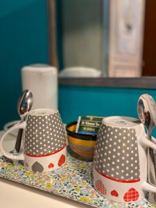 two polka dot coffee mugs sitting on a table at La Casa Del Poeta in Dervio