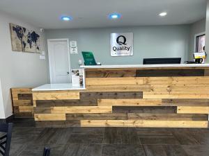 a store with a wooden wall in a room at Quality Inn in Monroe