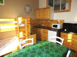 a kitchen with a bunk bed and a kitchen with a table at Residence Albion - Agréable petit studio offrant une belle vue dégagée ! MAE-7564 in Aix-les-Bains
