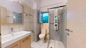 a bathroom with a toilet and a sink and a shower at Mediterraneo Resort in Parga +54 photos