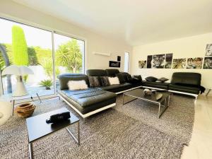 a living room with a couch and a table at Villa Du Golf De La Grande Motte - Maisons & Villas pour 12 Perso 044 in La Grande Motte