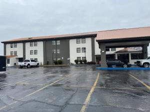 an empty parking lot in front of a building at Super 8 by Wyndham Blytheville in Blytheville