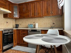 a kitchen with a table and chairs and cabinets at APARTAMENT CENTRUM in Nowe Miasto Lubawskie +93 photos