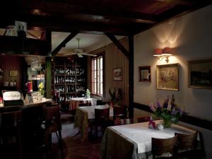 a dining room with two tables and a bar at Leśny Dworek in Wyszków